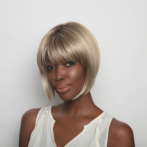 Short-length synthetic wig. This straight ready-to-wear wig is a sleek A-Line cut with full fringe.  Angie is machine made with adjustable tabs in the back nape area to allow a more comfortable fit. The result is a comfortable fit with a natural look that is both fashionable and easy to wear. Shown in Creamy Toffee-R